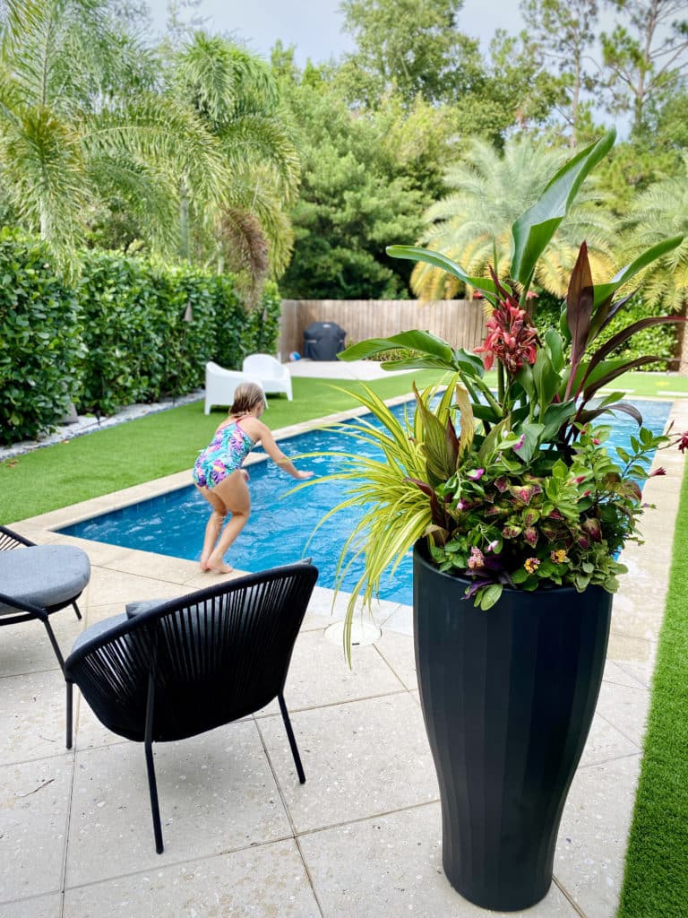 Tropical TruDrop Self-watering Planter sitting by the pool.